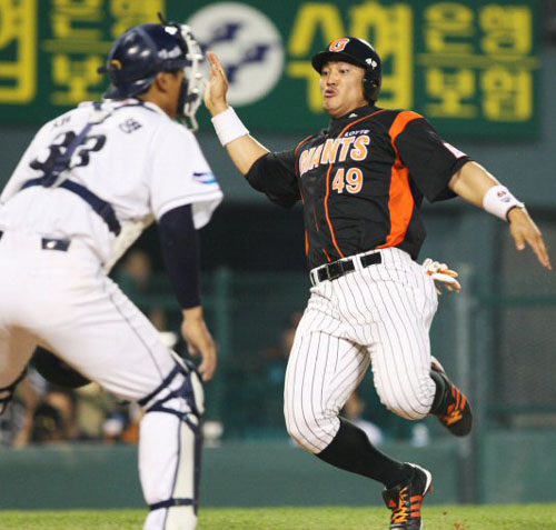   19일 잠실구장에서 열린 2009 CJ 마구마구 프로야구 두산과 롯데의 경기 5회초 무사 1루에서 롯데 김민성의 2루타때 홍성흔이 홈으로 파고들어 세이프되고 있다. 