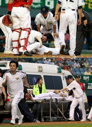 7일 서울 잠실야구장에서 벌어진 2009 프로야구 두산 베어스-SK 와이번스 경기, 두산 손시헌이 3회말 2사 1루 상황에서 SK 선발 투수 고효준이 던진 공에 머리를 맞아 실려나가고 있다. 