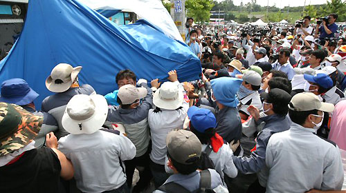  4일 오전 경기도 평택 쌍용자동차 평택공장 앞에서 점거 파업중인 노조원을 지지하는 진보 정당과 시민 단체의 천막을 쌍용차 사측 직원들이 철거하고 있다. 